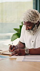 Review, notes or black man in home with remote work, auditing or forecast planning for funding pitch. WFH, space or mature wealth advisor with writing, budget insight or proposal draft for investment