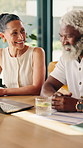 Finance, investment and interracial couple with documents in home for asset management together. Man, woman or smile with laptop, paperwork or drink for financial budget, bills or expenses in house