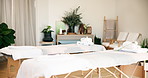 Empty, spa and bed for massage at resort, wellness retreat and atmosphere for body care. Interior, luxury or holistic therapy with bodywork table, lodge or hotel with cosmetic service or aromatherapy