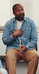Mental health, counseling or black man with discussion, support group or empathy in wellness clinic. Psychology, wellbeing or mature person with conversation, explaining or sharing story for advice.