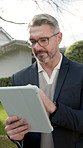 Man, realtor and reading at house with tablet, research and property viewing for real estate. Mature person, typing or seller outdoor with digital, new listing and information for residential auction