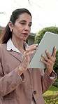 Woman, realtor and review at house with tablet, research and property viewing for real estate. Mature person, reading and outdoor tour with digital, new listing and information of residential auction