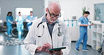Doctor, man and typing on tablet for healthcare report, admission request or telehealth in clinic. Staff, mature person and thinking with tech for lab results, schedule CT scan and care plan update