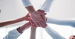 Hands together, doctors and team at hospital with goals, celebration and success in lobby. People, nurses or surgeon group with achievement, low angle and collaboration for motivation at clinic