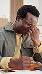 Tired, laptop and man in office with headache, exhausted and overwork pressure with glasses. Eye strain, burnout and black person on computer with stress in creative workplace, fatigue or migraine