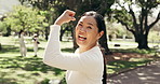 Woman, face and flexing for exercise outdoor with happiness, health and wellness with muscle in park. Mature, person and champion with strong bicep, laughing and portrait for active lifestyle