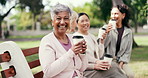 Laughing, friends and woman with coffee on park bench, face and smile at reunion together on break. Mature person, group and hangout outdoor with drink, funny humor and relax with portrait in nature