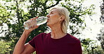 Break, water or woman in park with fitness, training pause or recovery with wellness activity. Hydration, cool down or mature person with bottle, workout rest or refreshing stop in outdoor exercise.