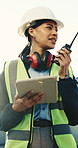 Woman, engineer or radio at construction site with tablet, building instruction or problem solving. Low angle, tech and supervisor at worksite for operations management, project update and contact