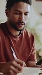 Man, phone and writing in home for remote work, calendar reminder and update for creative project. Freelancer, mobile and notebook in house for schedule planning, productivity and research notes