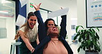 Fun, chair and women in office with push, colleague bonding and project finish with paper throw. Happy, laughing and employees with playful moment, team connection and report completion in workplace.