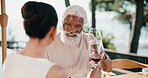 Celebration, wine or interracial couple outdoor with cheers, connection or bonding on anniversary. Love, smile or mature people with alcohol, partner toast or happy moment with marriage milestone.