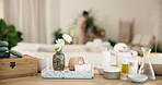Hospitality, candles and oil in spa for therapy, aromatherapy and person with setup for consultation. Employee, scent and flowers at health resort for aesthetic, service or ready for holistic healing