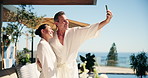 Couple, selfie and outdoor at resort with spa, bonding together or laugh for funny social media post. Happy, married mature people and relax at hotel with photography, humor and wellness retreat.