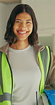 Electrician, face and woman with smile on construction site for building, safety or inspection. Supervisor, happy person and portrait with helmet for property evaluation, remodeling or renovation