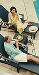 Couple, drinks and relax at swimming pool on vacation, anniversary and bonding with partner for love. Mature man, woman and champagne outdoor on holiday, travel and break at luxury hotel from above