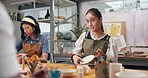 Pottery, woman and talk with sculpture in class for paint process, design compliment or art lesson. Happy, people or discussion in studio for ceramic decoration, creative workshop or praise technique
