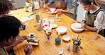 People, painting and workshop in art studio with pottery, design and learning for skill development. Artist, group and ceramics decoration in class with paintbrush, creativity and tools from above.