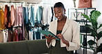 Fashion, tablet and black woman in clothing shop for stock review, online sales or small business. Tech, happy person or boutique entrepreneur with style update, scroll retail catalog or inventory