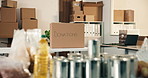 Office, donations and box with groceries for charity, canned food and non profit of poverty relief. Empty, workplace or supplies in cardboard for collection, pantry staple and aid package for welfare
