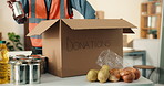 Hands, volunteer and box with groceries for donation, food drive and non profit of charity outreach. Person, packing and welfare in cardboard with supplies, pantry goods and parcel for poverty relief