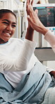 Happy, child and high five in hospital bed with pediatrician, good news and recovery from sickness. Healthcare worker, girl and celebration in clinic for healing, support and rehabilitation success.