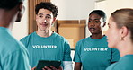 Volunteer, team and manager in NGO with tablet, conversation and instructions for outreach project. Leader, people and discussion in charity with tech, advice and guidance for non profit initiative.