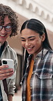 Happy, students and talk at university with phone, browsing social media or friends bonding together. People, smile and discussion outdoor on college campus with tech, connection or higher education.