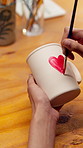Hands, person and painting in class with pottery, sculpture and custom design of handmade craft. Potter, paint brush and decoration in workshop with clay cup, artistic process and porcelain creation
