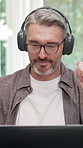 Headphones, laptop or man in home with video call, funding review or client advice in remote work. WFH, digital or mature finance advisor with tech, investment inquiry or discussion in online meeting