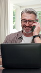 Remote work, phone call and happy man with laptop in home, publishing or communication with contact. Creative, freelancer and mature person with mobile, laugh and chat for ebook publication in house