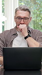 Freelancer, yawning and man with laptop in home, tired or typing article for publication on website. Remote work, writer and mature person with glasses, exhausted and editing story with tech in house