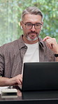 Earphones, laptop or man in home with video call, funding review or client advice in remote work. WFH, digital or mature finance advisor with tech, investment inquiry or discussion in online meeting.