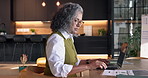 Remote work, document and woman with laptop in home, accountant or tax preparation with info on web. Freelance, senior bookkeeper and person with tech for budget, typing and financial report in house