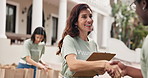 Volunteering, clipboard and woman with handshake for charity outdoor, task delegation or happy. People, shaking hands and food parcel for community outreach, checklist and sign up for nonprofit team