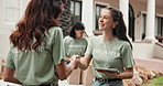 Happy, woman and volunteer outdoor with handshake, welcome and partnership for community service. Smile, team and shaking hands at event with tablet, introduction and agreement for charity enrollment