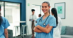Medical, face or woman in clinic with arms crossed, surgical assistant or confidence in patient care. Happy, doctor and nurse in hospital with pride, wellness service and about us in healthcare.