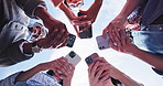 Outdoor, hands and friends with phone in circle for  networking, online connection or share contact. Low angle, group and people together with mobile for communication, smile or social media app