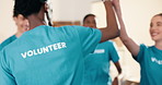 Volunteers, back or team in center with high five, support or group motivation for charity campaign. Happy, people or outreach workers with unity, encouragement or solidarity in welfare project.