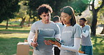 Volunteer, team or talking in park with tablet, distribution schedule or discussion with donation list. People, tech and planning in nature for food drive, checklist and community service for charity