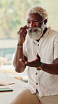 Digital, laugh and black man in house with phone call, connection and happy moment in remote chat. Space, talking or mature person with technology, discussion or joke reaction in online communication