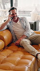 Digital, laugh and man on couch with phone call, connection and happy moment in remote chat. Contact, talking and mature person in home with tech, discussion or joke reaction in online communication.
