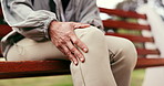Mature, person and hands with knee pain on park bench for fitness injury, break or recovery. Accident, outdoor rest or muscle tension with sore leg for discomfort, fibromyalgia or mistake in nature
