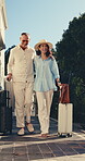 Travel, happy couple or luggage for hotel arrival, romantic trip or weekend stay at accommodation. Laugh, mature people or walk with suitcase for lodge entrance, guest check in or anniversary holiday