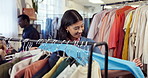 Shopping, sweater and happy woman in store with clothes, outfit search and decision in trendy style. Retail, check and customer in boutique with apparel, garment choice or option for fashion purchase