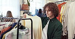 Shopping, rack and man in store with clothes, outfit search and decision with trendy style. Retail, sweater and customer in boutique with apparel, garment choice and option for fashion purchase.
