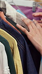 Shopping, choice and hands with clothes in store, customer and selection for purchase and discount. Fashion, boutique and person with clothing options, fabric and consumer with style decision in mall