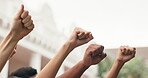 Fist, people and hands raised outdoor for protest, movement and awareness to stop violence. Activist, community and society resistance for humanitarian crisis, honoring victims and genocide justice