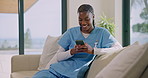 Nurse, woman and phone on couch with laugh, funny text message and social media post on work break. Happy, black person or healthcare worker in home with tech, internet meme or typing for online chat