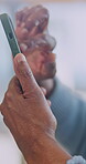 Scroll, old person and hands in home with phone, news search and online post on social media. Digital, browse and senior woman with tech, internet research and message review on virtual platform.